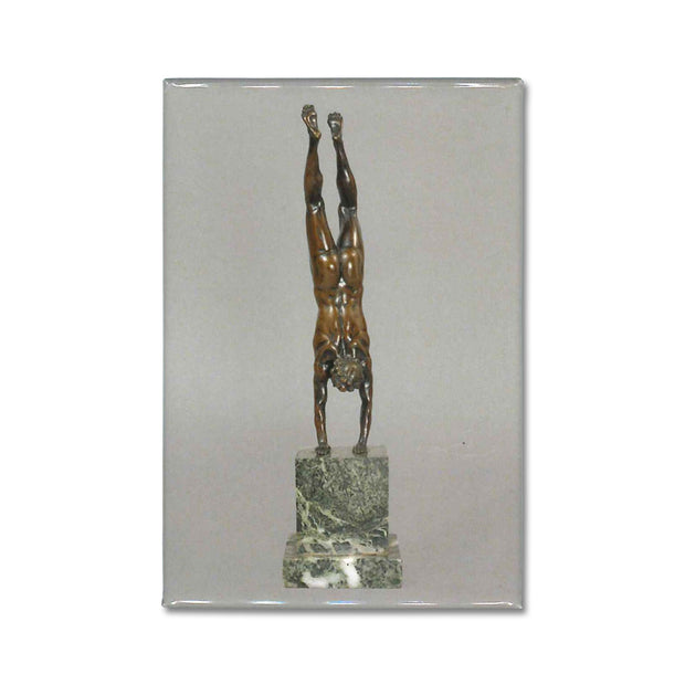 An Acrobat statuette reproduced on a souvenir magnet